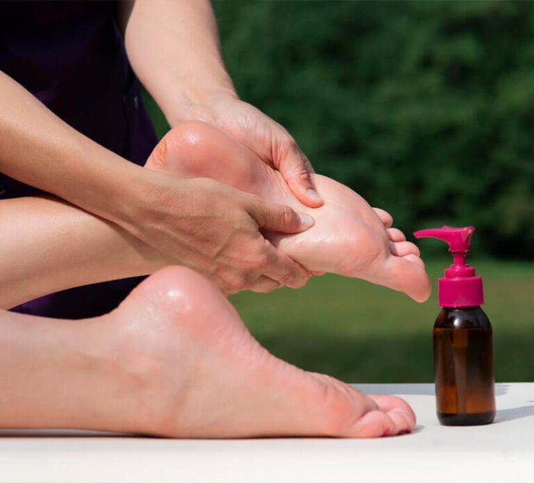 massage-feet-with-oil-outdoors