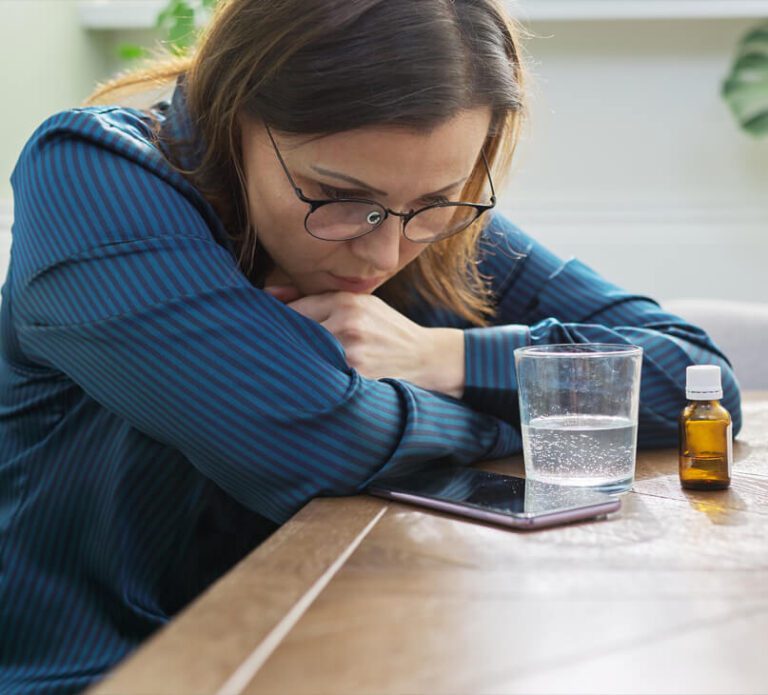 woman-with-medicine-glass-water-phone